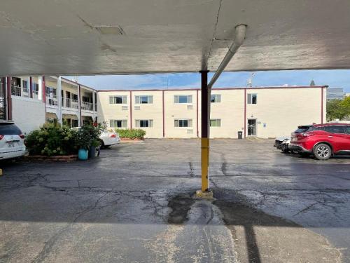 a parking lot with cars parked in front of a building at Village Inn Green Bay in Green Bay