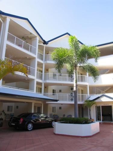 a building with a car parked in front of it at Golden Sands Beachfront Resort in Yorkeys Knob