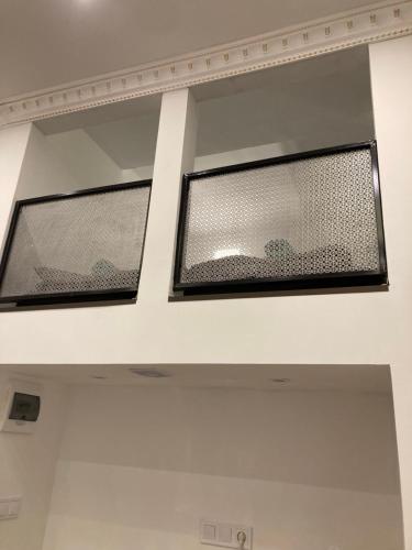two windows on the ceiling of a room at Roland Apartment Downtown - Keleti in Budapest