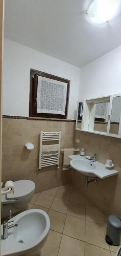 a bathroom with two sinks and a window at Sweet Home in Chiaravalle