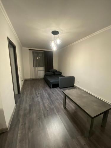 a living room with a couch and a coffee table at 2 Cosy Apartment in townhouse near Airport EVN in Geghanist