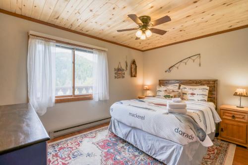 um quarto com uma cama e uma ventoinha de tecto em Valley of The Pines Chalet em Red River
