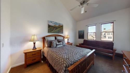 a bedroom with a bed and a couch at Ski In, Ski Out, 3 Bedroom Luxury Residence In The Heart Of Snowmass Village in Snowmass Village