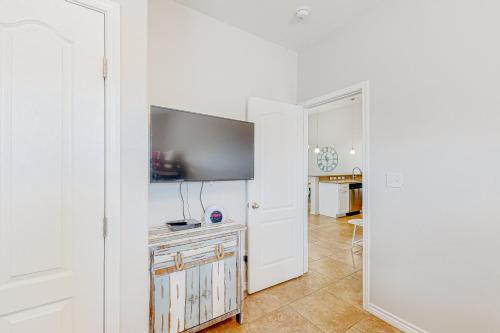 a living room with a flat screen tv on a wall at Morgan Shores in Port Aransas