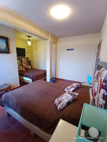 a bedroom with a large bed and a table at Hotel Posada Spa Antigua Casa Hogar in Taxco de Alarcón