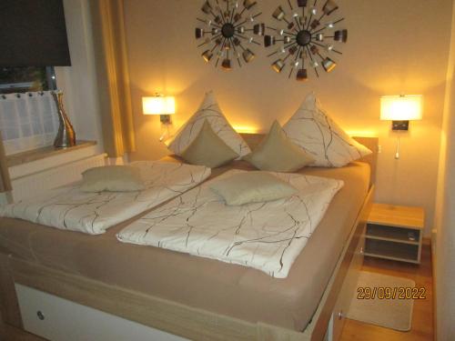 a bedroom with a bed with white sheets and pillows at Zentrale-ruhige Ferienwohnung in Reichenbach im Vogtland