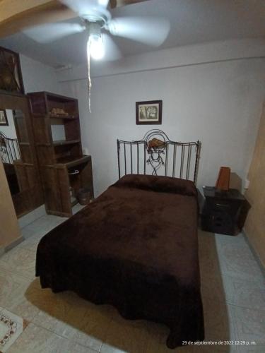 a bedroom with a bed and a ceiling fan at Hotel Posada Spa Antigua Casa Hogar in Taxco de Alarcón