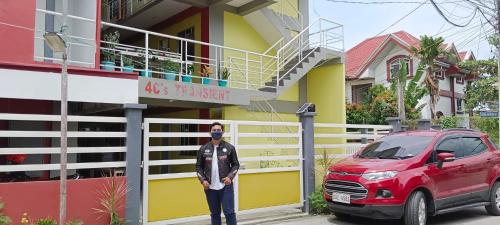 a man standing in front of a house at 4C’s Room Rental, Apartments, Hotel and Transient in Calapan
