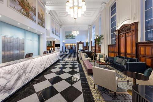 a lobby of a hotel with a checkered floor at Adina Apartment Hotel Brisbane in Brisbane