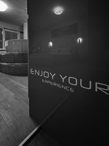 a sign that says enjoy your experience in a room at sky FLAT jacuzzi sauna 27 FLOOR in Klaipėda