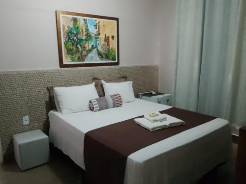 a hotel room with a bed with a tray on it at Pousada da Gi Suítes e Turismo in Chapada dos Guimarães