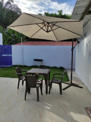 a table and chairs and an umbrella on a patio at Casa Quinta el Refugio in Flandes