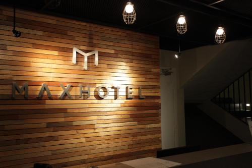 a sign on a wooden wall with the word marriott at MAX Hotel Subang Jaya in Subang Jaya