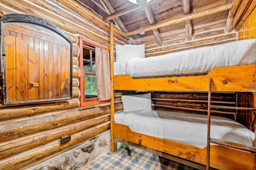 a bedroom with two bunk beds in a log cabin at Minerva's Log Cabin Gem in Minerva