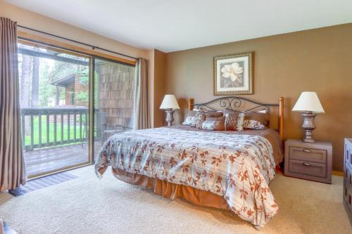 a bedroom with a bed and a large window at It's Always Sunny in Sunriver in Sunriver