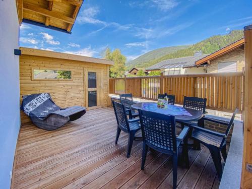 a patio with a table and chairs on a deck at Krammer Großvenediger in Neukirchen am Großvenediger