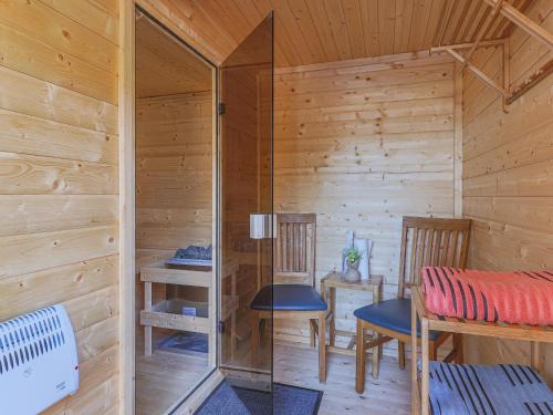a wooden cabin with two chairs and a table at Krammer Großvenediger in Neukirchen am Großvenediger