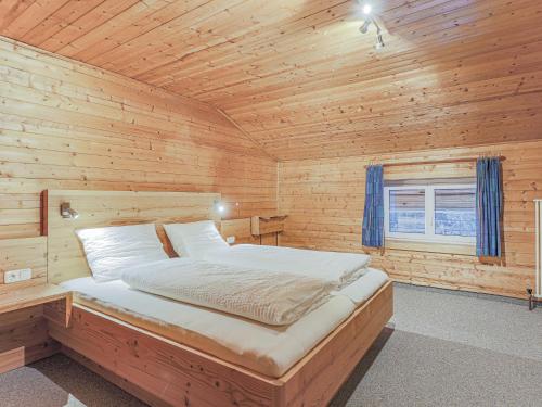 a bedroom with a bed in a wooden cabin at Glonersbühelhof Top 1 in Westendorf