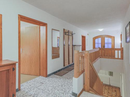 a hallway with wooden doors and stairs in a house at Glonersbühelhof Top 2 in Westendorf