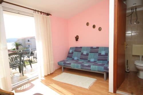 a bedroom with a bed and a balcony at Triple Room Pasman 8223e in Pašman