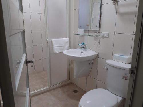 a bathroom with a toilet and a sink and a shower at Chin-Lan B&B in Zhuangwei