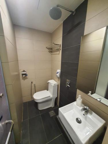 a bathroom with a white toilet and a sink at GG Hotel Bandar Sunway in Petaling Jaya
