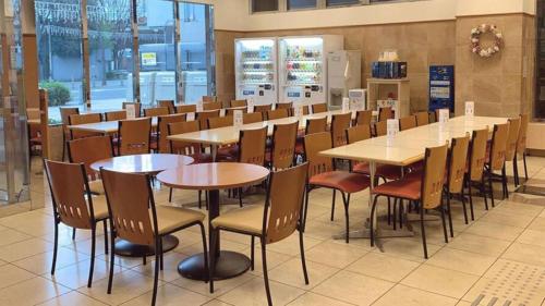 a row of tables and chairs in a restaurant at Toyoko Inn Kagoshima Temmonkan No 2 in Kagoshima