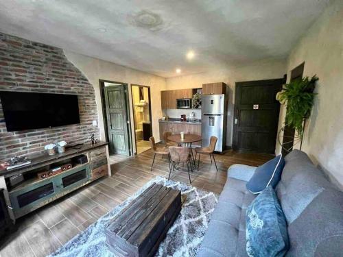 a living room with a couch and a kitchen at Master Loft en Valquirico in Santeagueda