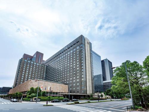 a large building with many windows in a city at Imperial Hotel Tokyo in Tokyo