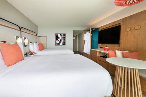 a hotel room with a large bed and a tv at Crowne Plaza Resort Guam in Tumon