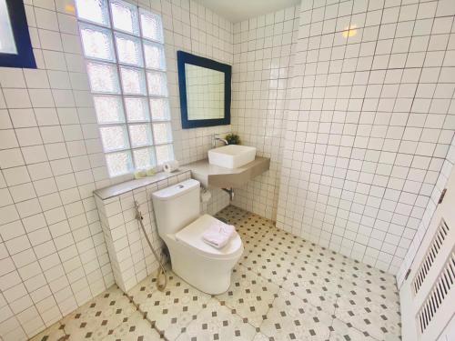 a white bathroom with a toilet and a sink at The Retreat Ao nang Private Pool Villa in Ao Nang Beach