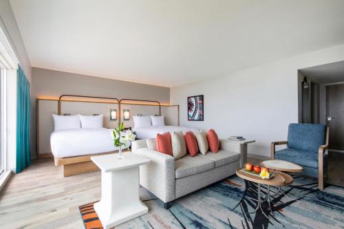 a hotel room with a bed and a couch at Crowne Plaza Resort Guam in Tumon
