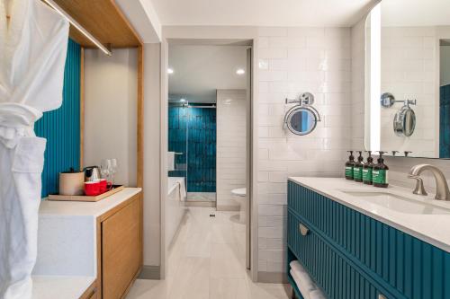 a bathroom with a sink and a blue cabinet at Crowne Plaza Resort Guam in Tumon