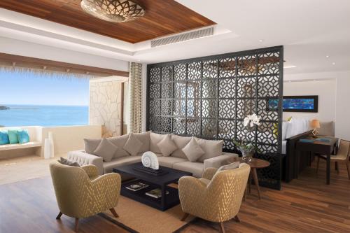 a living room with a couch and a table at Banana Island Resort Doha by Anantara in Doha