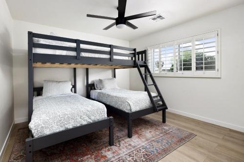 two bunk beds in a room with a ceiling fan at South Scottsdale w/ Chef's Kitchen & Golf Nearby!! in Scottsdale