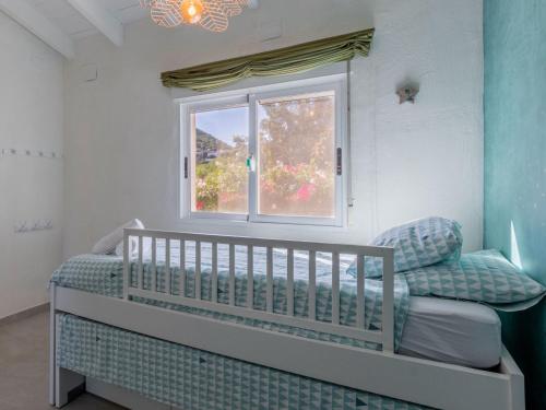 a baby crib in a room with a window at Scenic Villa, Costa Blanca in Denia
