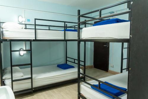 a room with four bunk beds in a room at The Beach Hostel Krabi Beach in Ao Nang Beach