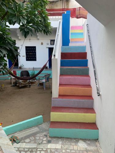 a colorful staircase with a hammock on the side of a house at Shiva Guest House in Pushkar