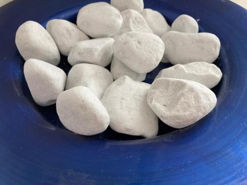 a blue bowl filled with white rocks at Gasthof Lublass in Matrei in Osttirol