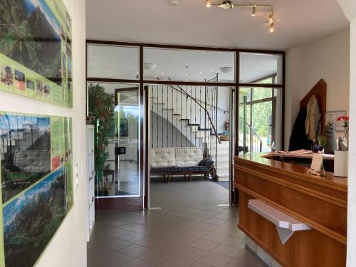 a lobby with glass doors and a staircase in a house at Gasthof Lublass in Matrei in Osttirol