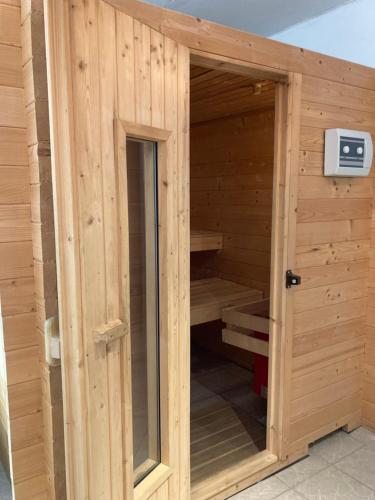 a wooden sauna with a door in a building at Gasthof Lublass in Matrei in Osttirol