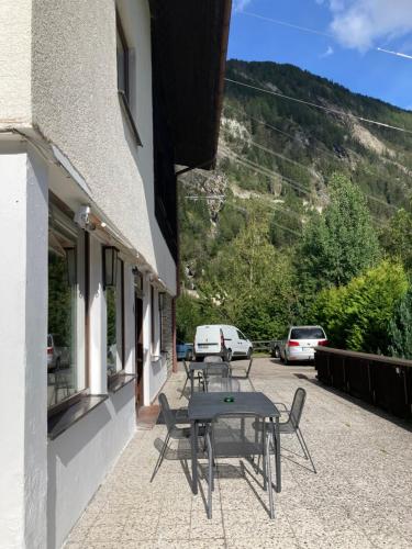 a table and chairs on the side of a building at Gasthof Lublass in Matrei in Osttirol