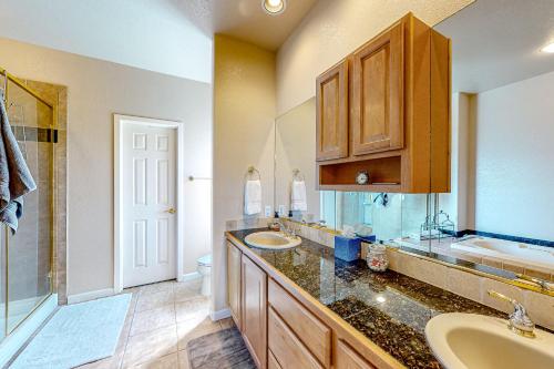 a bathroom with two sinks and a toilet and a shower at High Country Haven in Pagosa Springs