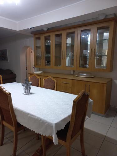 a kitchen with a white table and wooden cabinets at Caribbean Estates Private Villas in Port Edward