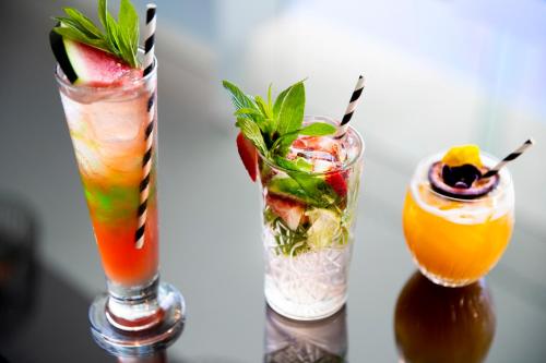 two cocktails sitting on top of a table at Pullman Magenta Shores Resort in The Entrance