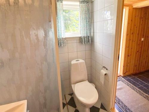 a small bathroom with a toilet and a window at 4 person holiday home in MÅLØY-By Traum in Måløy