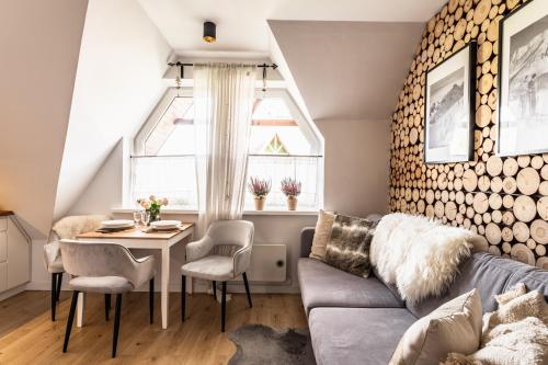 a living room with a couch and a table at Apartament pod Wierchem in Zakopane