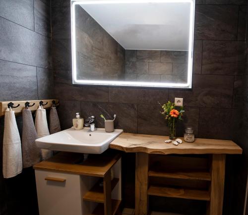 a bathroom with a sink and a mirror at Exclusive House in Olofström