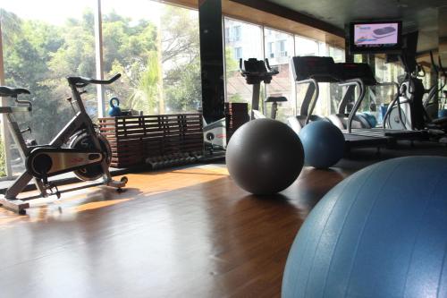 a gym with several exercise bikes and a large window at Mercure Surabaya Grand Mirama in Surabaya