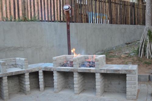 a fire pit in the middle of a yard at Luxury Tented Village @ Urban Glamping in St Lucia